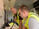 Oregon Office of Emergency Management Communication Officer Fred Molesworth, AF7S, (left), and Amateur Radio volunteer Patrick Lewis, KDØDUA, demonstrate Amateur Radio at the Oregon State Fair in August. [Oregon Office of Emergency Management photo by Cory E. Grogan] 